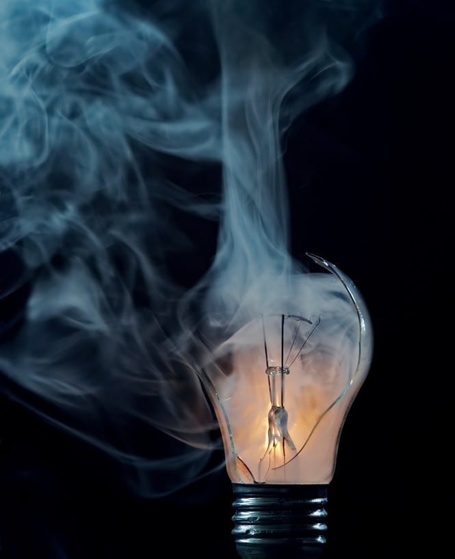 Shattered Smoking Light Bulb Symbolizing Broken Innovation