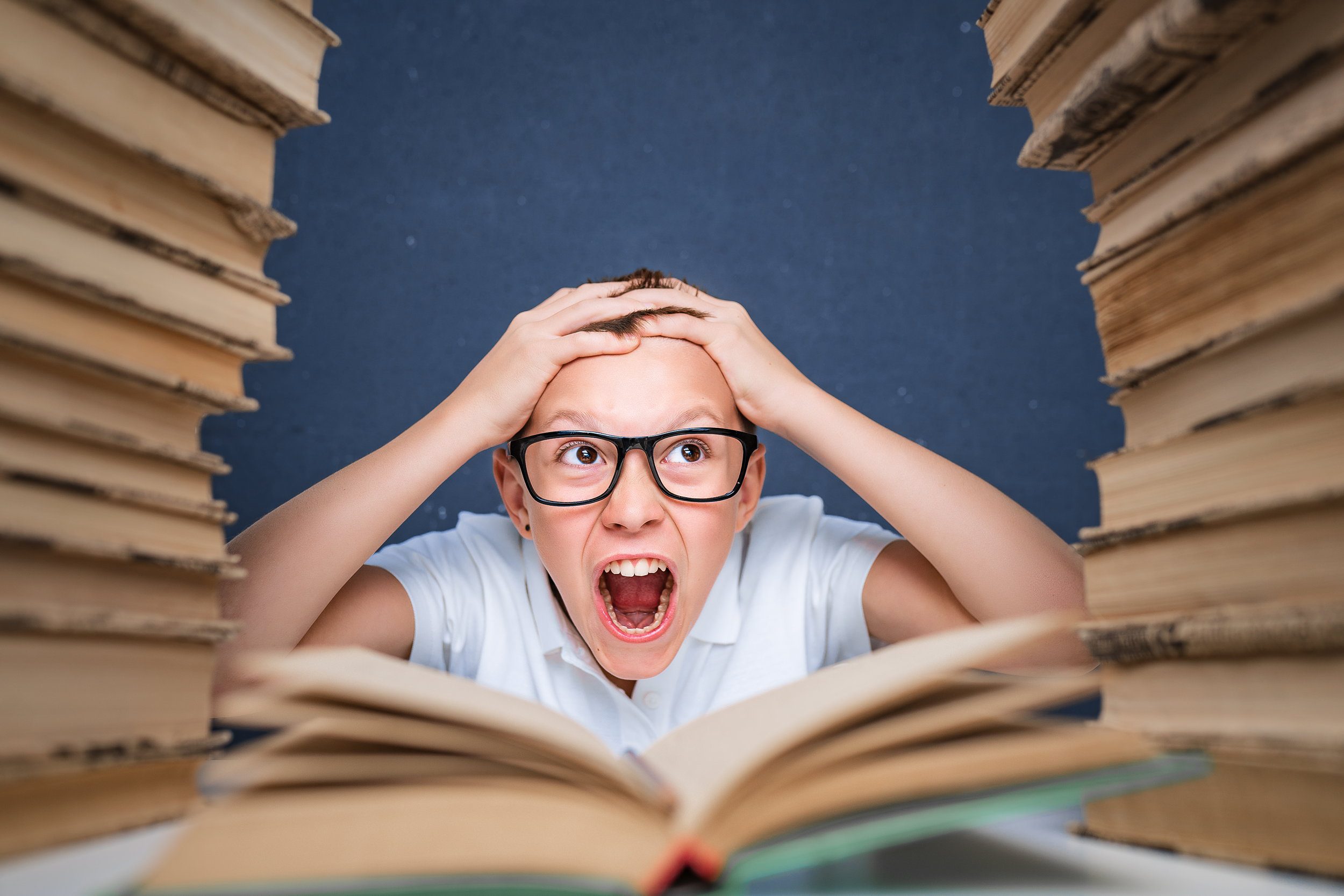 Boy Overwhelmed with Books to Read